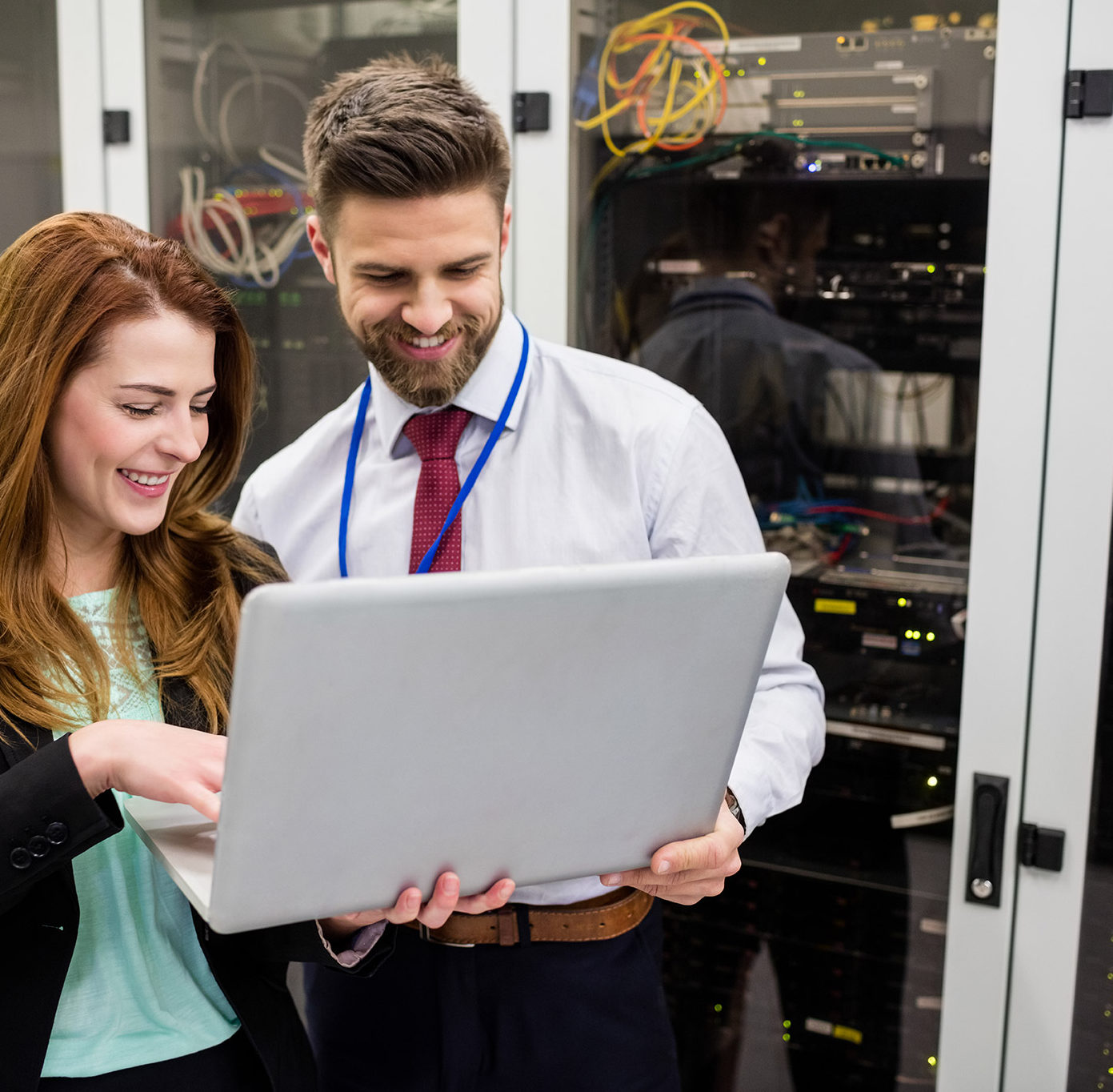 technicians-using-laptop-while-analyzing-server-CC4MP6J